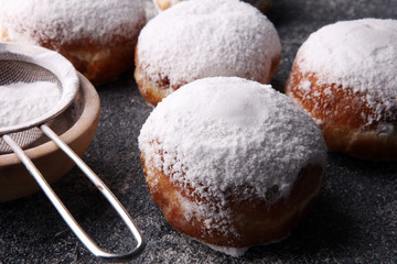 German donuts with jam and icing sugar. Carnival powdered sugar raised donuts