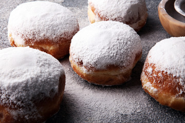 German donuts with jam and icing sugar. Carnival powdered sugar raised donuts