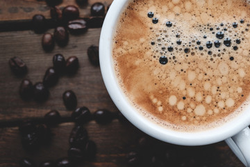 Fresh cup of coffee with beans