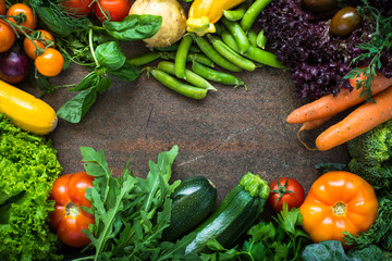 Organic farmer vegetables on dark slate table. Top view. Food frame background.