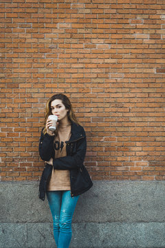 Woman with paper cup on street