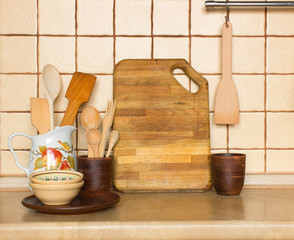 Fototapeta na wymiar Utensils and dishware on kitchen shelf. Kitchen interior background