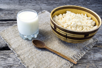 Homemade cottage cheese in a plate on a wooden table