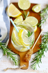Obraz na płótnie Canvas Glasses with Fresh Water Rosemary Lemon Lime Fruits White Background Beverage Healthy Lifestyle