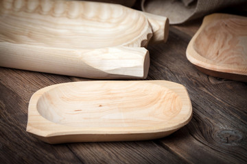 Old wooden utensils on a brown table.