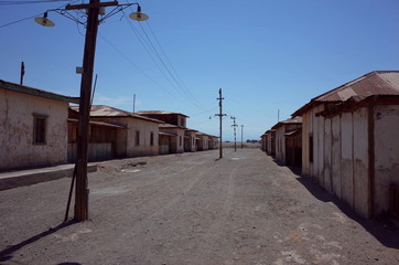 Fototapeta na wymiar An eerie street in the abandoned Humberstone saltpeter works. This abandoned nitrate town was extremely important for the early economy of Chile