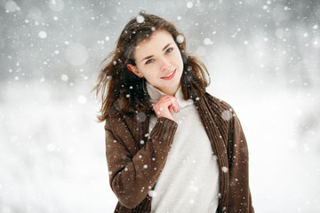 Beautiful winter portrait of young woman in the winter snowy scenery. Happy winter moments. Christmas Girl - 189672625