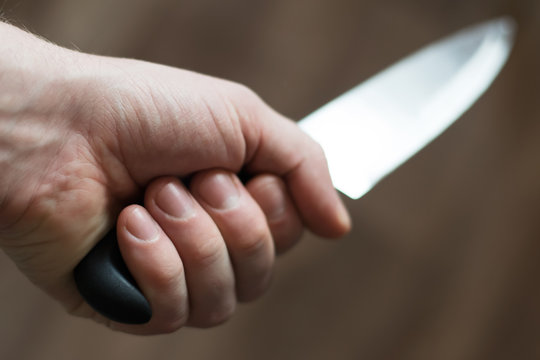 man's hand with a kitchen knife