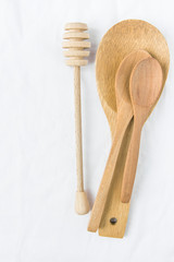 Wooden Honey Dipper Spoons on White Linen Fabric Background Table. Holiday Baking Cooking Workshop Course Announcement Template. Craftsmanship Artisanal Products. Styled Image for Social Media Blog
