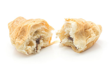 Broken baked croissant or cornetto isolated on white background two halves with chocolate cream inside.
