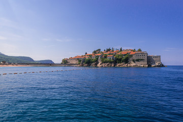 Fototapeta na wymiar Distance view of small Island of Sveti Stefan on the Adriatic Sea in Montenegro