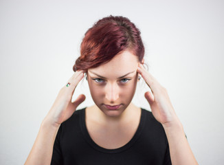 A young girl with facial expression, and hands shows that the pain is headache, headache, pain, white background, facial expressions