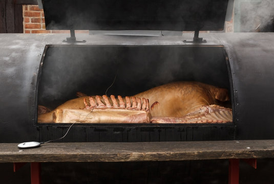 Barbecued Pig Rosted Whole in a Metal Grill