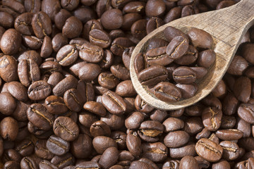 Roasted coffee on the wooden background - Coffea