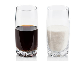 glass of sugar compared with cola refresh drink in sweet excess calories content, diet and glucose addiction concept isolated on white background