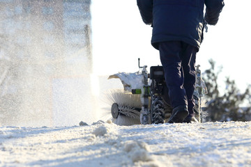 man cleaning the street from snow manual tractor special.