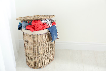 Bin with dirty clothes prepared for laundry indoors