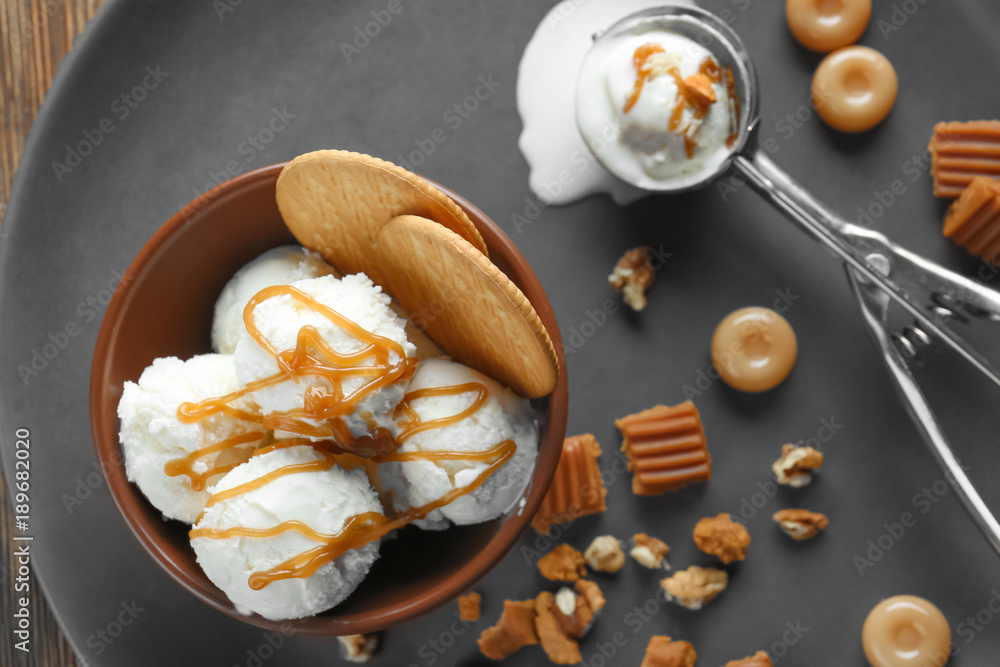 Sticker composition with ice cream, caramel sauce, candies and nuts on table