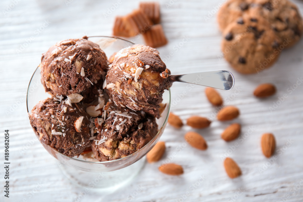 Sticker dessert bowl with caramel ice cream on white wooden table