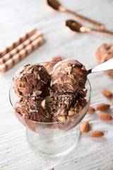 Dessert bowl with caramel ice cream on white wooden table