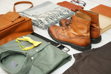 Set of stylish male hipster clothes on wooden background