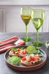 Tasty bruschettas with prosciutto, tomatoes and mozzarella on plate