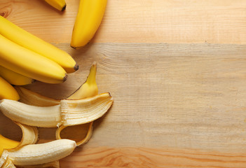 Ripe bananas on wooden background