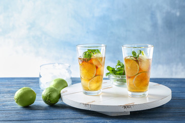 Glasses with Cuba Libre cocktail on wooden board