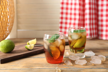 Glasses with Cuba Libre cocktail on wooden table