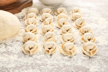 Raw meat dumplings on table