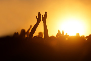 Rock concert, silhouettes of happy people raising up hands © 9parusnikov