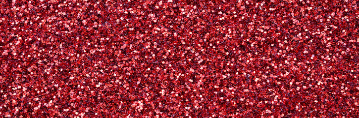 A huge amount of red decorative sequins. Background texture with shiny, small elements that reflect light in a random order. Glitter texture
