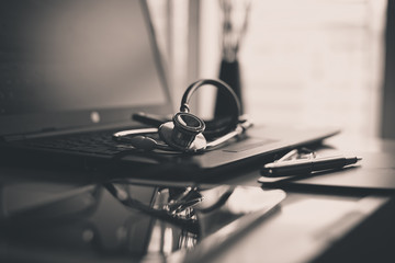 Close up of red stethoscope on desk,Healthcare and medical concept,Black and white toned