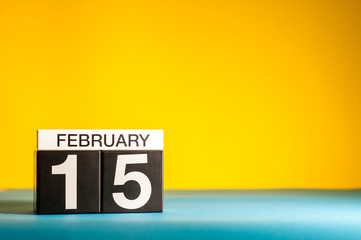 February 15th. Day 15 of february month, calendar on yellow background. Winter time. Empty space for text