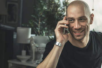 Young man having a cheerful phone call