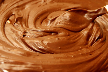 Melted chocolate as background /  By melting chocolate, you create a tool for dipping, topping, and decorating with chocolate