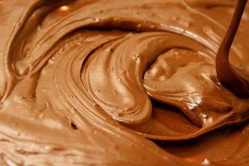 Melted chocolate as background /  By melting chocolate, you create a tool for dipping, topping, and decorating with chocolate