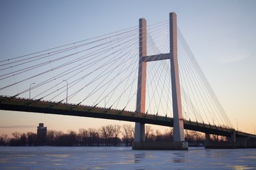Fototapeta na wymiar Bridge and a frozen river at sunrise