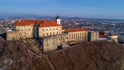 Fototapeta na wymiar Beautiful panoramic aerial view to Palanok Castle at sunset and the city of Mukachevo
