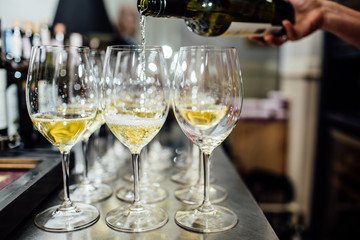 waiter brings glasses of champagne