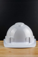 HEALTH AND SAFETY CONCEPT. Personal protective equipment on wooden table over black background.