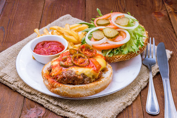 open hamburger with jalapeno and french fries 