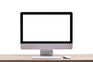 Modern desktop computer on wooden table. Studio shot isolated on white. Blank screen for graphics display montage