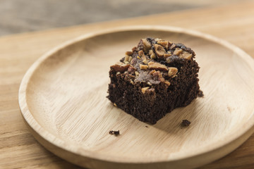 Chocolate brownie dessert on wooden background close up