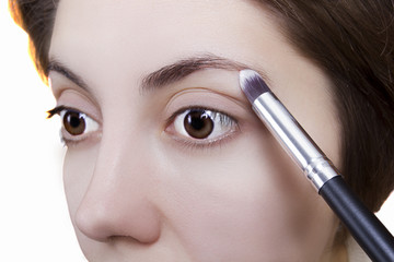 Naklejka premium Young woman doing makeup