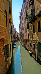 Fototapeta na wymiar Narrow canal of Venice