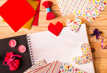 hand made origami paper hearts for valentine's day surrounded by origami paper