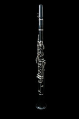 Full view of a clarinet standing isolated in black