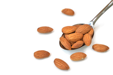 Almond in a spoon on white background - isolated