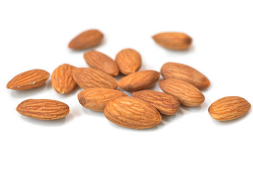 Almond in a spoon on white background - isolated